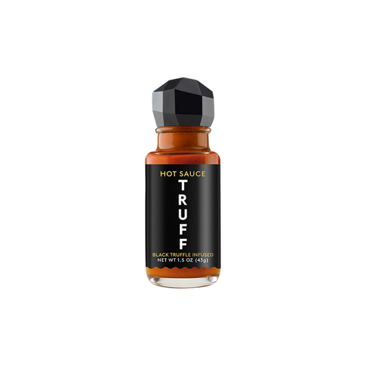 Hot sauce bottle with black truffle label on a white background
