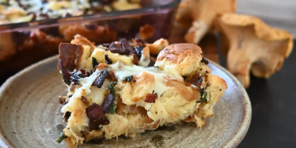 Baked dish with cheese and herbs on a ceramic plate