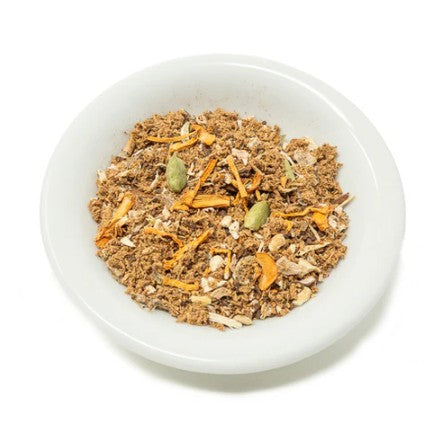 Muesli with carrots and seeds in a white bowl on a white background