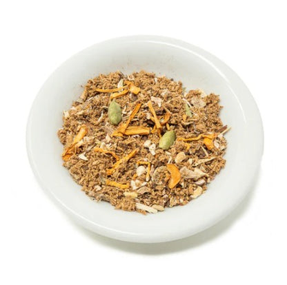 Muesli with carrots and seeds in a white bowl on a white background
