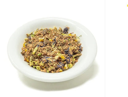Dried herbs in a white bowl on a white background