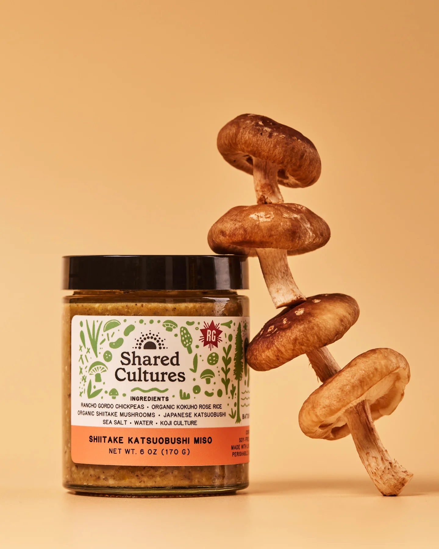 Jar of 'Shared Cultures' miso with shiitake mushrooms on a beige background